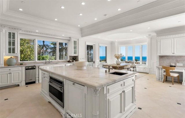 71 Ritz Cove Dr, Dana Point, CA 92629 - kitchen with an island with sink, a sink, decorative backsplash, white cabinets, and recessed lighting