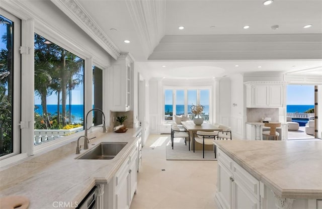 71 Ritz Cove Dr, Dana Point, CA 92629 - kitchen with a sink, ornamental molding, backsplash, a water view, and light stone counters