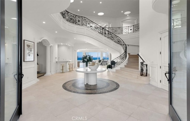 71 Ritz Cove Dr, Dana Point, CA 92629 - entrance foyer with ornamental molding, decorative columns, recessed lighting, stairway, and a decorative wall
