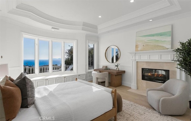 71 Ritz Cove Dr, Dana Point, CA 92629 - bedroom with a tray ceiling, crown molding, a high end fireplace, recessed lighting, and light wood finished floors