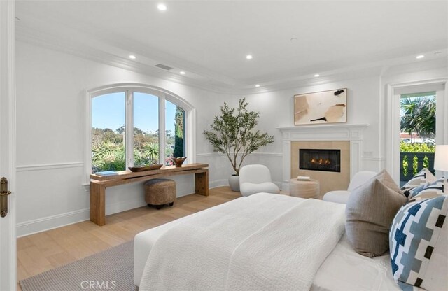 71 Ritz Cove Dr, Dana Point, CA 92629 - bedroom featuring recessed lighting, wood finished floors, multiple windows, a glass covered fireplace, and baseboards