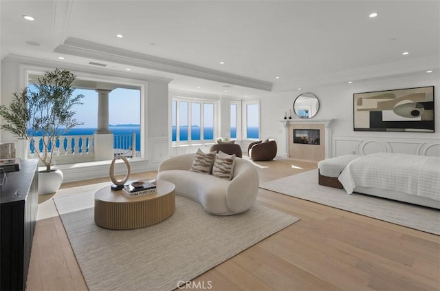 71 Ritz Cove Dr, Dana Point, CA 92629 - bedroom with a raised ceiling, crown molding, recessed lighting, wood finished floors, and a premium fireplace