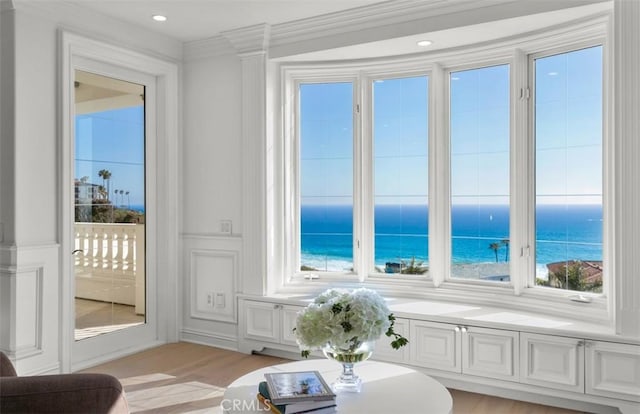 71 Ritz Cove Dr, Dana Point, CA 92629 - sitting room featuring a decorative wall, a water view, crown molding, light wood-style flooring, and recessed lighting