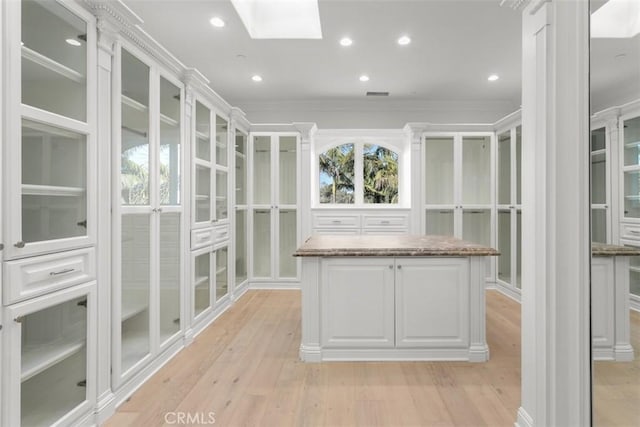 71 Ritz Cove Dr, Dana Point, CA 92629 - walk in closet featuring light wood finished floors and a skylight