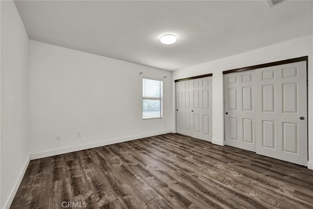 19270 Mountain S, Hidden Valley Lake, CA 95467 - unfurnished bedroom with multiple closets, dark wood-style flooring, and baseboards