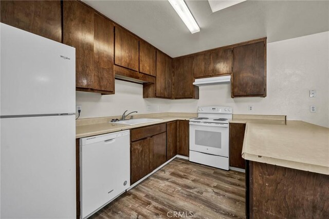 19270 Mountain S, Hidden Valley Lake, CA 95467 - kitchen featuring white appliances, a sink, dark wood-style floors, under cabinet range hood, and light countertops