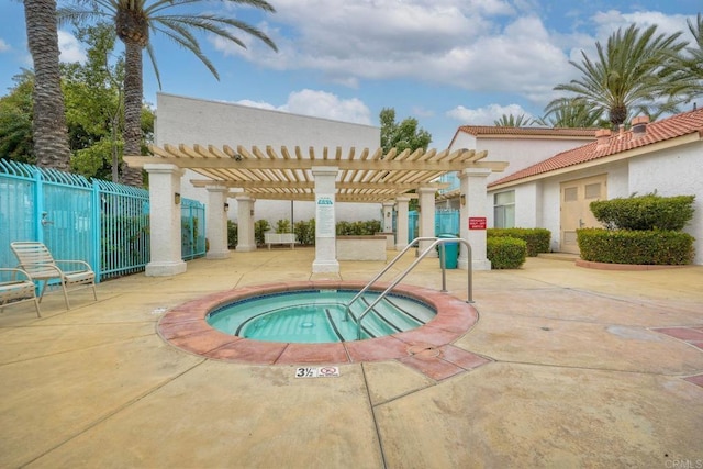 view of pool with a hot tub, fence, a pergola, and a patio area