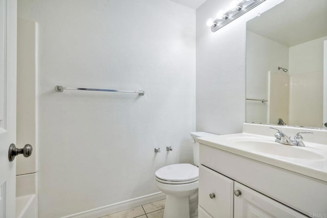 bathroom with a shower, tile patterned flooring, toilet, vanity, and baseboards