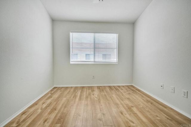 unfurnished room featuring light wood-style floors and baseboards