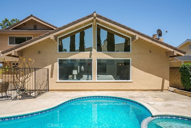 3238 N Hartman St, Orange, CA 92865 - rear view of house with stucco siding, a patio, and a pool with connected hot tub