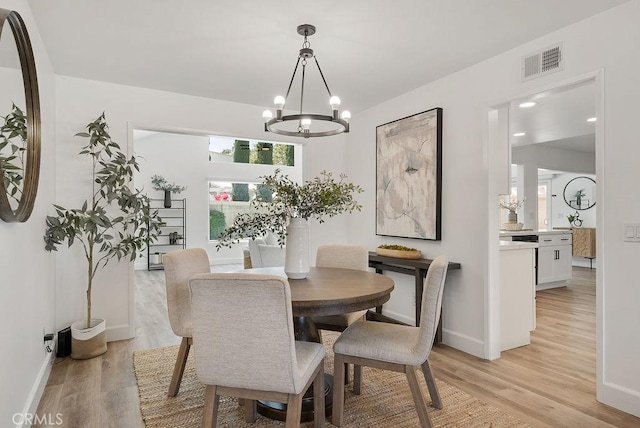 3238 N Hartman St, Orange, CA 92865 - dining area featuring a chandelier, light wood-style floors, and baseboards
