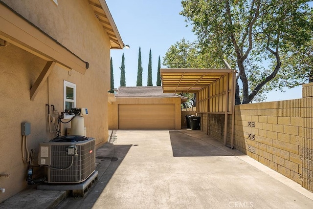 3238 N Hartman St, Orange, CA 92865 - view of side of home with stucco siding, driveway, a garage, central AC, and fence