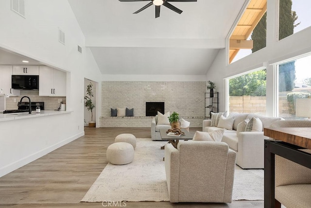 3238 N Hartman St, Orange, CA 92865 - living area with ceiling fan, high vaulted ceiling, beamed ceiling, light wood-style flooring, and wine cooler