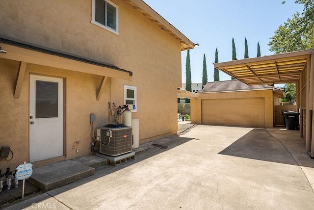 3238 N Hartman St, Orange, CA 92865 - view of property exterior with stucco siding, central AC unit, a garage, and an outbuilding