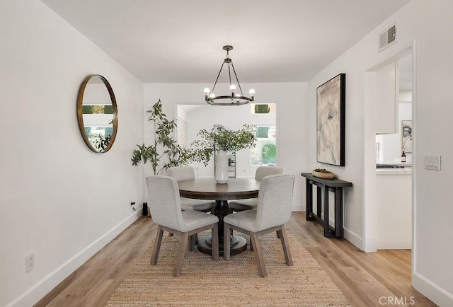 3238 N Hartman St, Orange, CA 92865 - dining room with a chandelier, light wood-style flooring, and baseboards