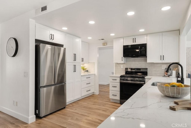 3238 N Hartman St, Orange, CA 92865 - kitchen with stainless steel appliances, a sink, light stone counters, light wood-type flooring, and recessed lighting