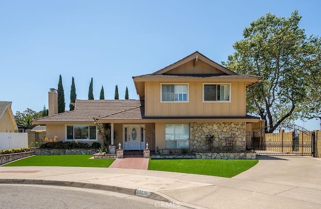 3238 N Hartman St, Orange, CA 92865 - view of front of home with a gate, board and batten siding, and a chimney