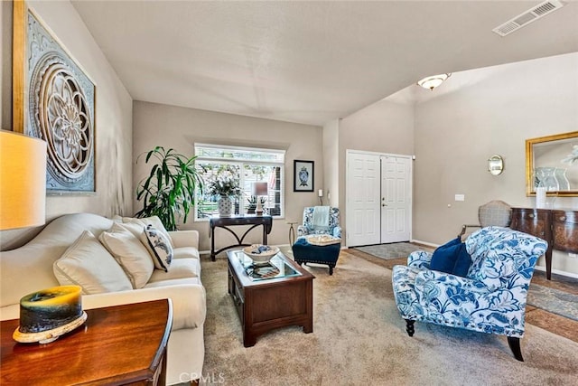 carpeted living room featuring baseboards