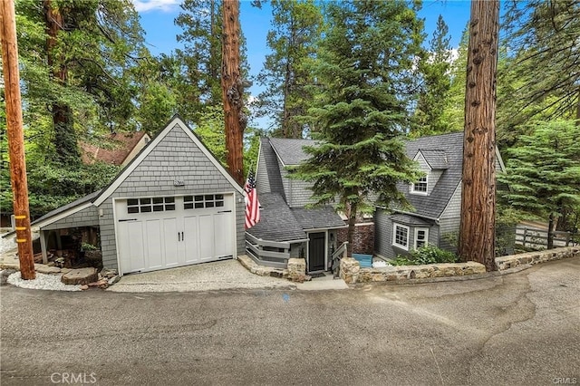 27844 Greenway Dr, Lake Arrowhead, CA 92352 - shingle-style home featuring a garage and roof with shingles