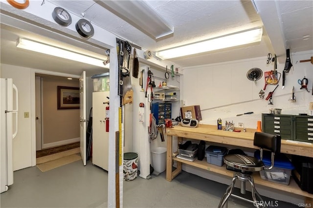 27844 Greenway Dr, Lake Arrowhead, CA 92352 - basement featuring a workshop area and freestanding refrigerator