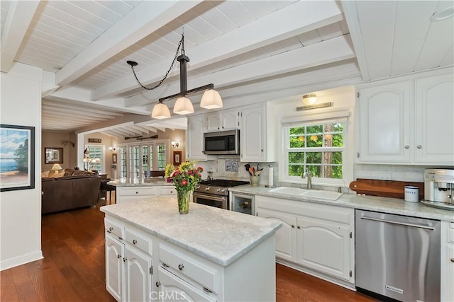 27844 Greenway Dr, Lake Arrowhead, CA 92352 - kitchen with appliances with stainless steel finishes, a sink, tasteful backsplash, open floor plan, and beamed ceiling