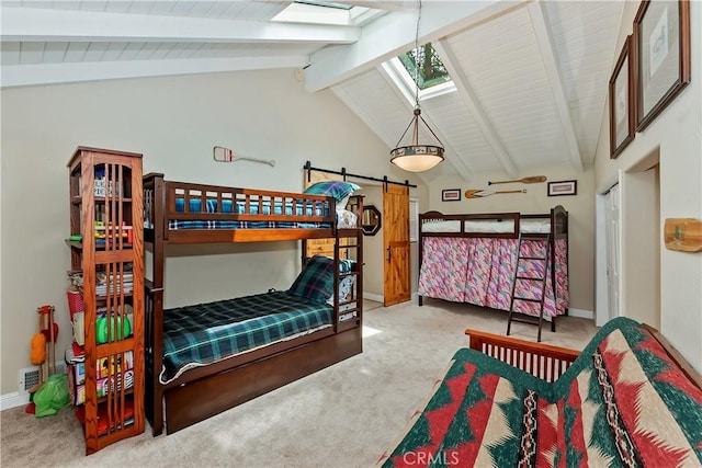 27844 Greenway Dr, Lake Arrowhead, CA 92352 - bedroom featuring a skylight, carpet floors, baseboards, and a barn door