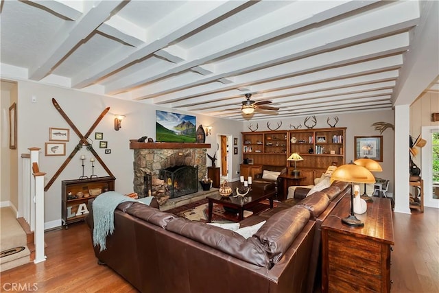 27844 Greenway Dr, Lake Arrowhead, CA 92352 - living area featuring wood finished floors, a fireplace, beam ceiling, a ceiling fan, and baseboards