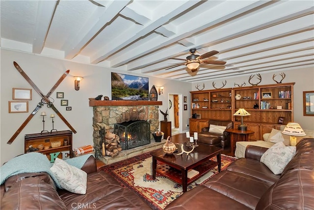 27844 Greenway Dr, Lake Arrowhead, CA 92352 - living room featuring a stone fireplace, beam ceiling, and a ceiling fan