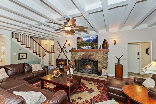 27844 Greenway Dr, Lake Arrowhead, CA 92352 - living area featuring ceiling fan, wood finished floors, stairs, a stone fireplace, and beamed ceiling