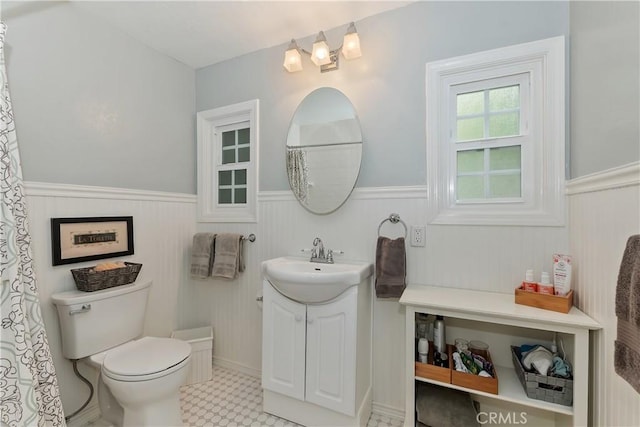 27844 Greenway Dr, Lake Arrowhead, CA 92352 - full bathroom featuring wainscoting, vanity, toilet, and tile patterned floors
