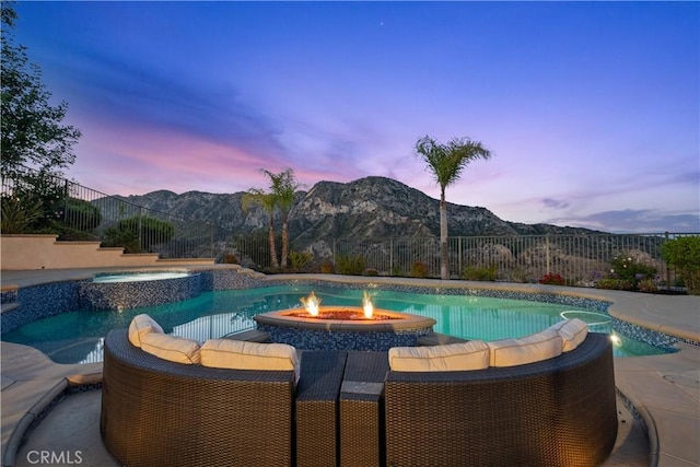25865 Tulip Grove St, Stevenson Ranch, CA 91381 - pool at dusk featuring a mountain view and a pool with connected hot tub
