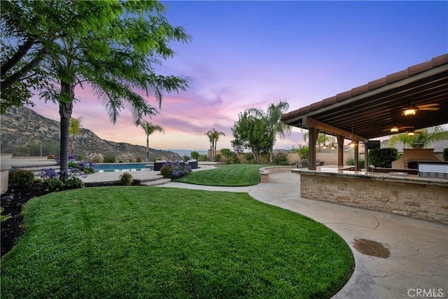 25865 Tulip Grove St, Stevenson Ranch, CA 91381 - yard at dusk featuring area for grilling, a lawn, an outdoor pool, and a patio area