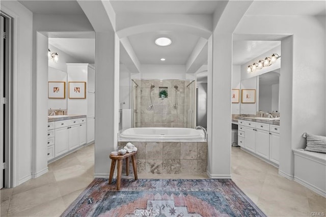 25865 Tulip Grove St, Stevenson Ranch, CA 91381 - bathroom featuring a tile shower, tiled bath, vanity, and tile patterned flooring
