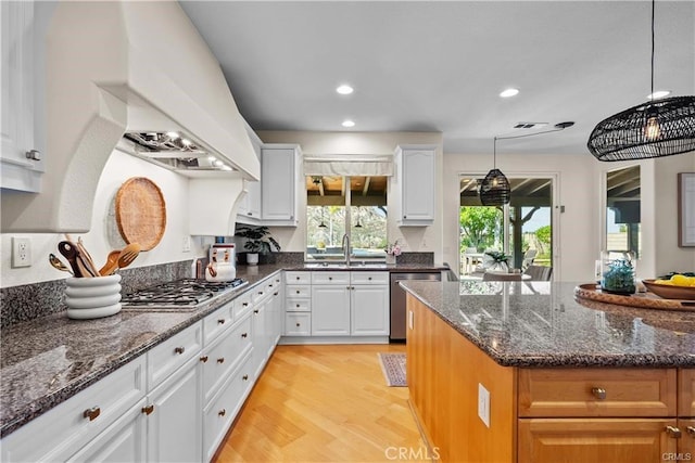25865 Tulip Grove St, Stevenson Ranch, CA 91381 - kitchen featuring stainless steel appliances, light wood-type flooring, recessed lighting, white cabinetry, and dark stone countertops