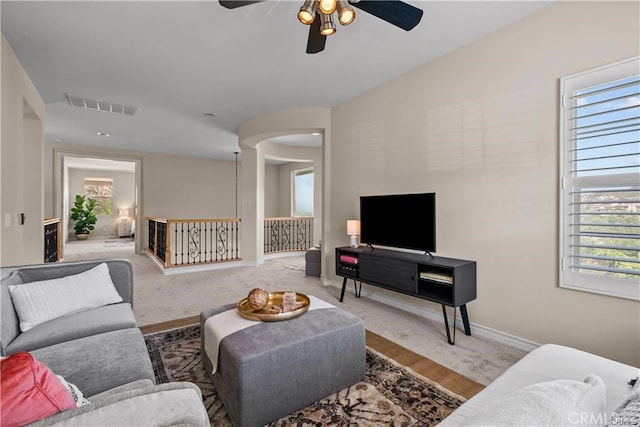25865 Tulip Grove St, Stevenson Ranch, CA 91381 - carpeted living room with ceiling fan, healthy amount of natural light, and arched walkways