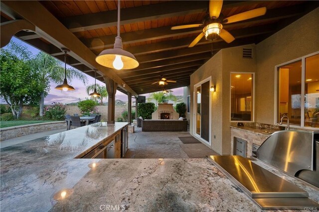 25865 Tulip Grove St, Stevenson Ranch, CA 91381 - view of patio with an outdoor stone fireplace, exterior kitchen, and ceiling fan