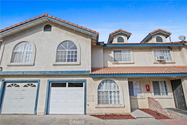 14118 Orizaba Ave Unit 7, Paramount, CA 90723 - multi unit property with a tile roof, stucco siding, an attached garage, driveway, and cooling unit