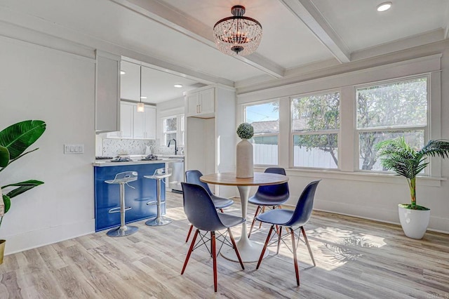 dining area with light wood-type flooring, baseboards, beamed ceiling, recessed lighting, and a chandelier