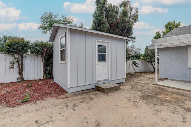 view of shed with fence