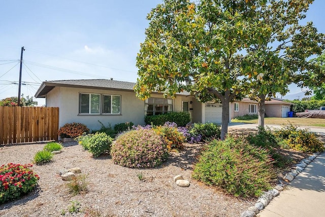 ranch-style house with stucco siding, a garage, fence, and concrete driveway