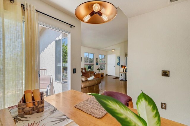 7488 Altiva Pl, Carlsbad, CA 92009 - dining space featuring lofted ceiling and wood finished floors