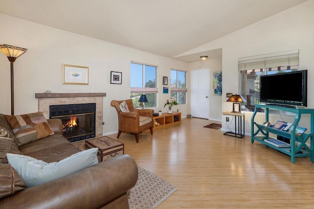 7488 Altiva Pl, Carlsbad, CA 92009 - living area featuring wood finished floors, a premium fireplace, vaulted ceiling, and baseboards