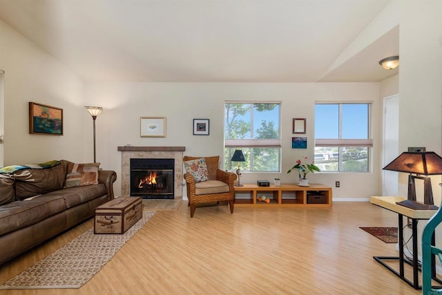 7488 Altiva Pl, Carlsbad, CA 92009 - living area with wood finished floors, a premium fireplace, and plenty of natural light