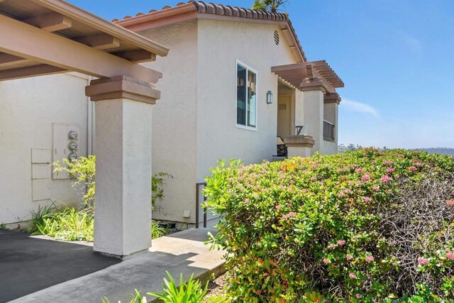 7488 Altiva Pl, Carlsbad, CA 92009 - view of property exterior featuring stucco siding and a tiled roof