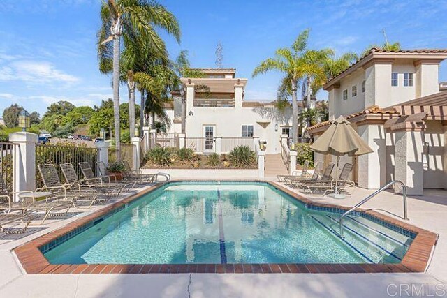 7488 Altiva Pl, Carlsbad, CA 92009 - community pool featuring a patio, fence, and a pergola