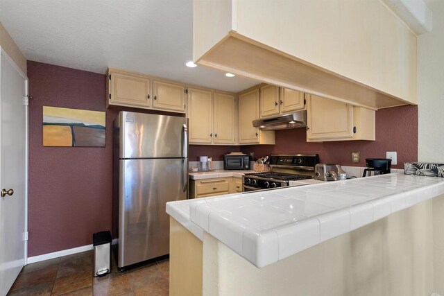 7488 Altiva Pl, Carlsbad, CA 92009 - kitchen featuring appliances with stainless steel finishes, tile countertops, under cabinet range hood, recessed lighting, and baseboards
