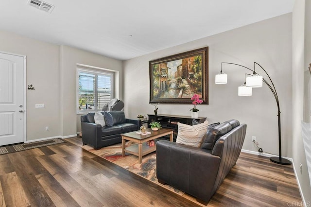 living area with wood finished floors and baseboards