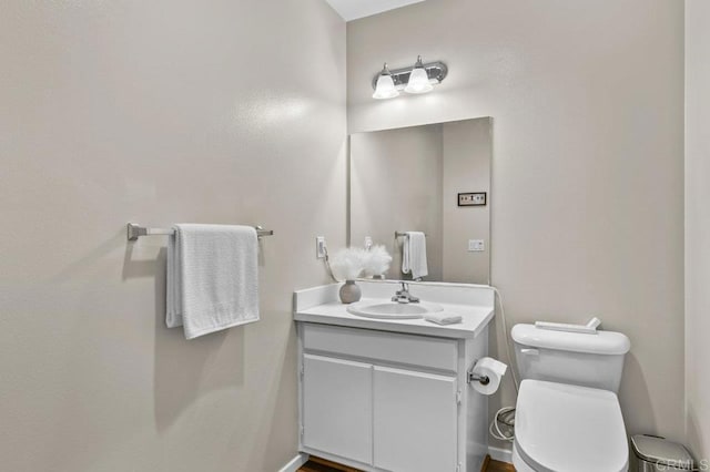 bathroom featuring vanity and toilet