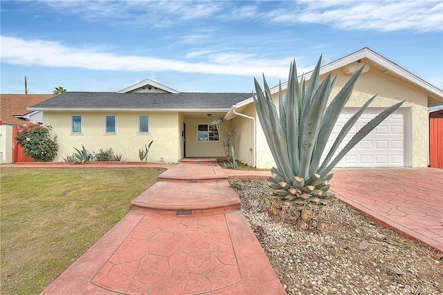 914 Lidford Ave, La Puente, CA 91744 - view of front of property featuring stucco siding, a garage, a front lawn, and decorative driveway