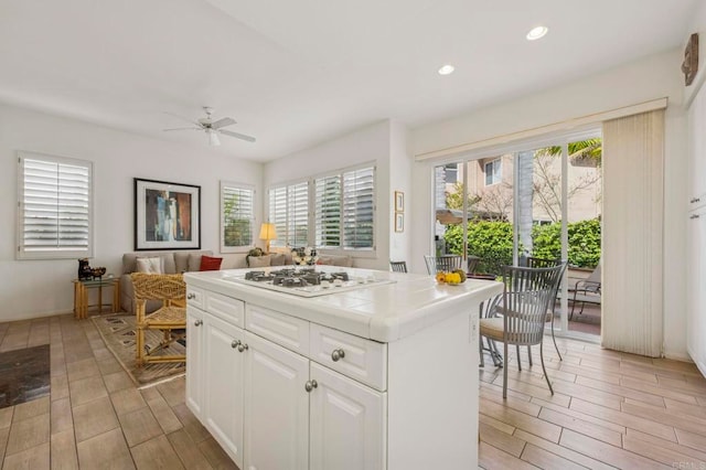 7256 Surfbird Cir, Carlsbad, CA 92011 - kitchen with tile countertops, white gas stovetop, ceiling fan, wood finish floors, and recessed lighting
